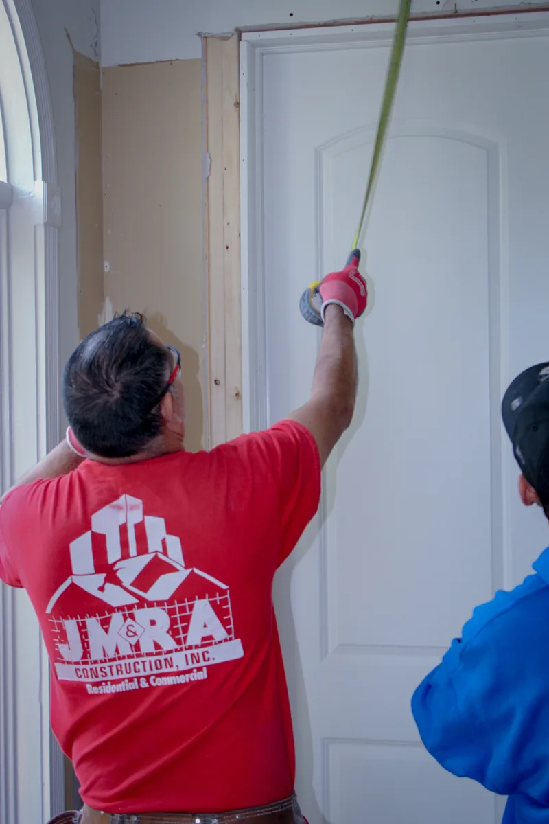 JMRA carpenter measuring a door frame