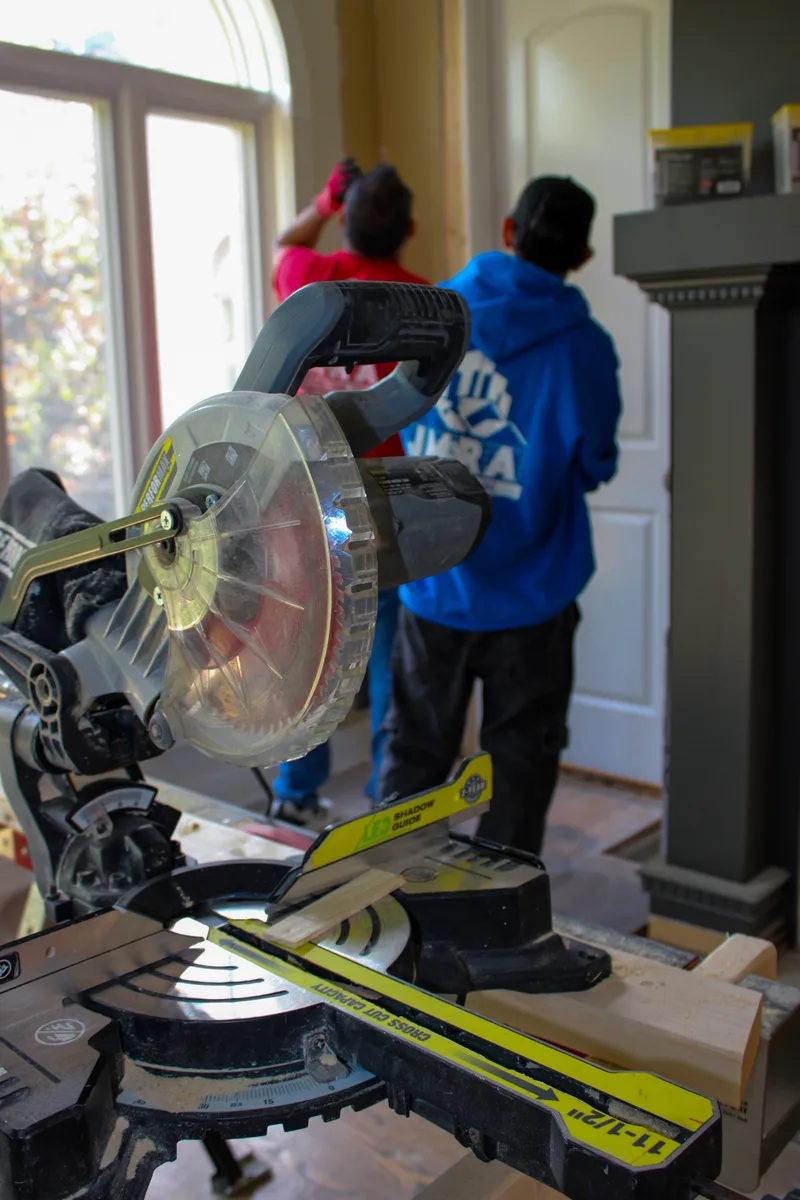 Miter saw ready for finish cuts while the crew works